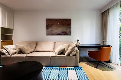 a living room with a couch and a desk at Private garden Laguna beachside 150 m Bangtao in Bang Tao Beach