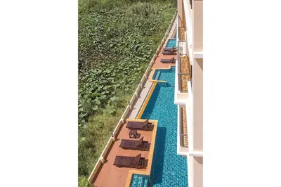 an overhead view of a hotel pool with tables and chairs at LAGO APARTMENTS BY TROPICLOOK in Nai Harn Beach