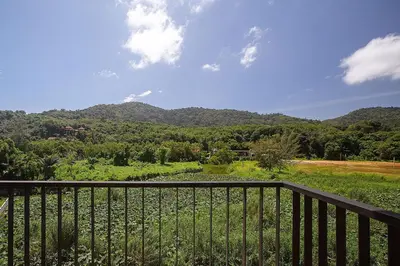 a balcony with a view of a mountain at LAGO APARTMENTS BY TROPICLOOK in Nai Harn Beach