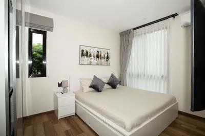 a white bedroom with a bed and a window at ME5 Halo 2-bedroom ВатСaп66935B2I976 вид на бассейн in Nai Yang Beach