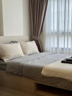 a bed with white pillows and a window in a bedroom at Poolside Paradise, Nice pool view in Kathu