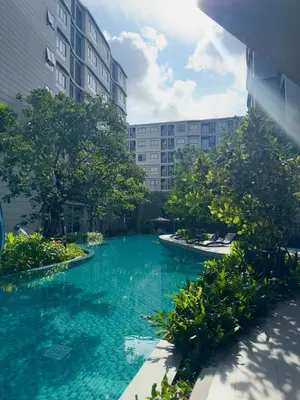 a pool of blue water in front of a building at Poolside Paradise, Nice pool view in Kathu