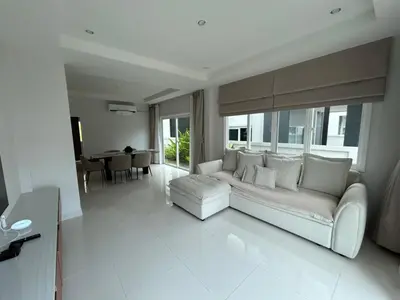 a white living room with a couch and a table at Supalai Rent BANG TAO PHUKET in Phuket