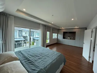 a bedroom with a large bed and a large window at Supalai Rent BANG TAO PHUKET in Phuket