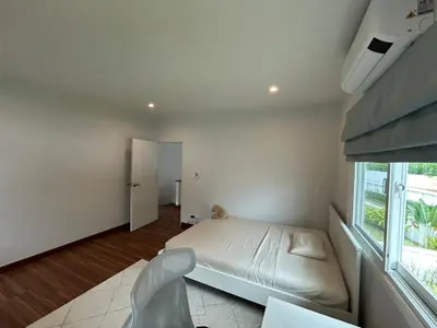 a white bedroom with a bed and a window at Supalai Rent BANG TAO PHUKET in Phuket