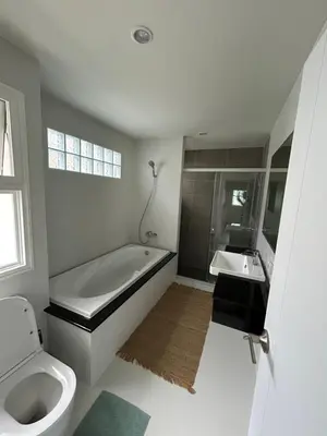 a bathroom with a tub and a toilet and a sink at Supalai Rent BANG TAO PHUKET in Phuket