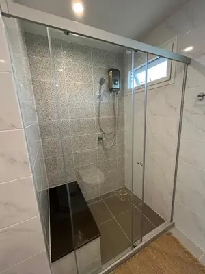 a shower with a glass door in a bathroom at Supalai Rent BANG TAO PHUKET in Phuket