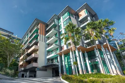 a building with palm trees in front of it at Sea view apartment in Phuket in Patong Beach