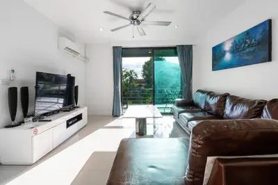 a living room with a couch and a flat screen tv at Sea view apartment in Phuket in Patong Beach