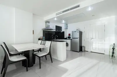 a kitchen with a table and chairs and a refrigerator at Sea view apartment in Phuket in Patong Beach