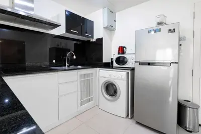 a kitchen with a refrigerator and a washing machine at Sea view apartment in Phuket in Patong Beach