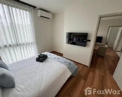 a bedroom with a large white bed and a flat screen tv at VE1 Halo 2-bedroom ВатСaп66935B2I976 in Nai Yang Beach