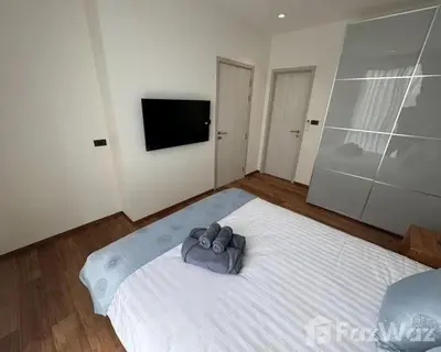 a bedroom with a large white bed and a flat screen tv at VE1 Halo 2-bedroom ВатСaп66935B2I976 in Nai Yang Beach
