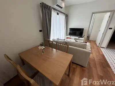 a living room with a table and a couch at VE1 Halo 2-bedroom ВатСaп66935B2I976 in Nai Yang Beach