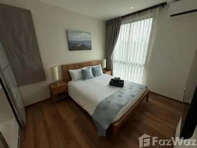 a bedroom with a bed and a large window at VE1 Halo 2-bedroom ВатСaп66935B2I976 in Nai Yang Beach