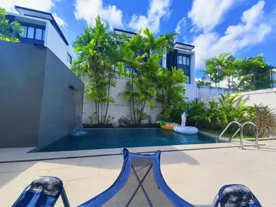 a swimming pool with a hammock in front of a house at \u65e0\u5c18\u522b\u9662 Pure Haven Villa in Ban Phru Champa