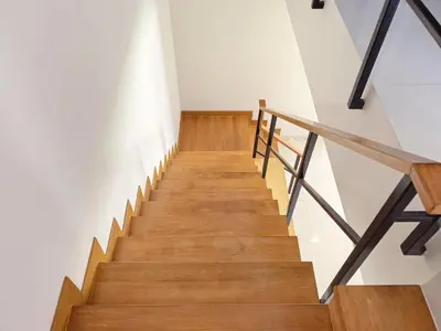 a staircase in a house with wooden floors and white walls at \u65e0\u5c18\u522b\u9662 Pure Haven Villa in Ban Phru Champa