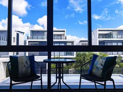 two chairs and a table in front of a window at \u65e0\u5c18\u522b\u9662 Pure Haven Villa in Ban Phru Champa