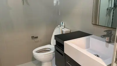 a bathroom with a white toilet and a sink at The deck patong 2bedroom in Patong Beach