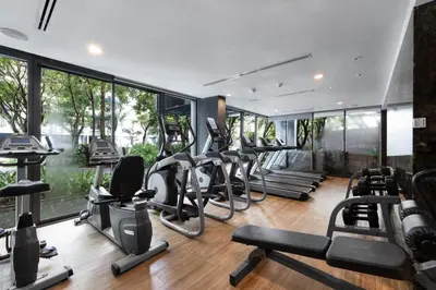 a gym with many treadmills and elliptical machines at The deck patong 2bedroom in Patong Beach