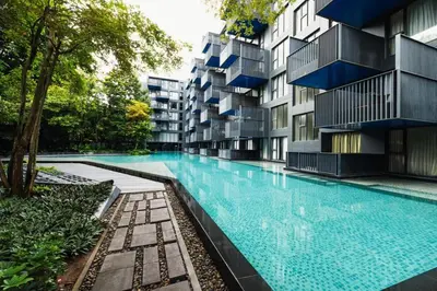 an apartment building with a large swimming pool at The deck patong 2bedroom in Patong Beach