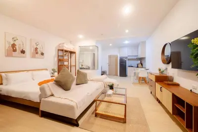 a living room with a bed and a couch and a table at Seaview Residence Karon beach in Karon Beach