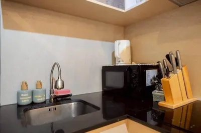 a kitchen with a sink and a microwave at Seaview Residence Karon beach in Karon Beach