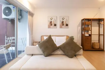 a living room with a couch with two pillows at Seaview Residence Karon beach in Karon Beach