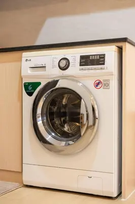 a white washing machine sitting in a cabinet at Seaview Residence Karon beach in Karon Beach