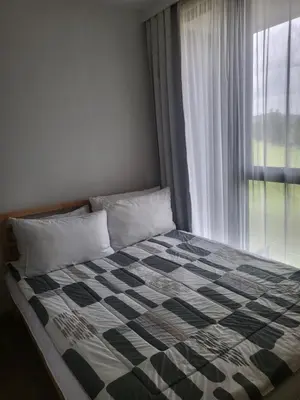 a bed in a bedroom with a window at Sky Park Laguna Residences F5 in Laguna Phuket