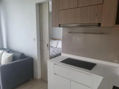 a kitchen with a sink and a couch in a room at Sky Park Laguna Residences F5 in Laguna Phuket