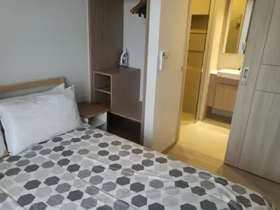 a bedroom with a bed with a black and white checkered at Sky Park Laguna Residences F5 in Laguna Phuket