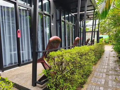 a row of benches sitting outside of a building at Finlay Cottage Aonang in Ban Khlong Haeng