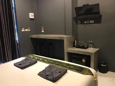 a bedroom with a bed with two towels on it at Finlay Cottage Aonang in Ban Khlong Haeng