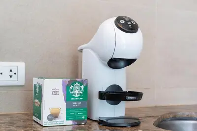 a coffee maker sitting on a counter next to a box at Kata Ocean View I05 in Karon Beach