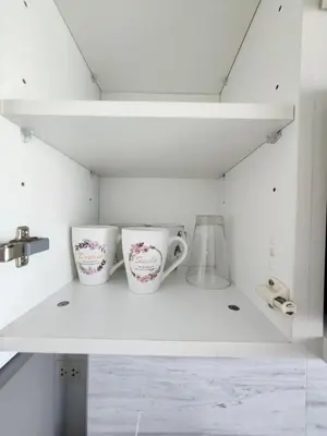 two cups sitting on top of a white shelf at cen 1 bed room859 in Ban Rangeng