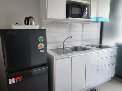 a small kitchen with a sink and a microwave at cen 1 bed room859 in Ban Rangeng