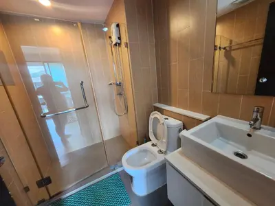 a bathroom with a toilet and a shower and a sink at cen 1 bed room859 in Ban Rangeng