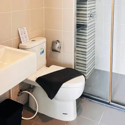 a bathroom with a toilet and a sink and a shower at Vista Phuket Old Town Gym Pool Wifi Netflix Walk to All in Phuket Town