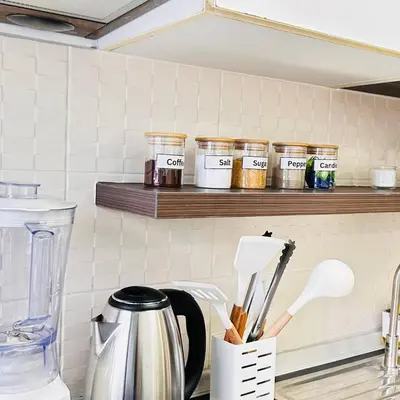 a kitchen counter with jars on a shelf at Vista Phuket Old Town Gym Pool Wifi Netflix Walk to All in Phuket Town