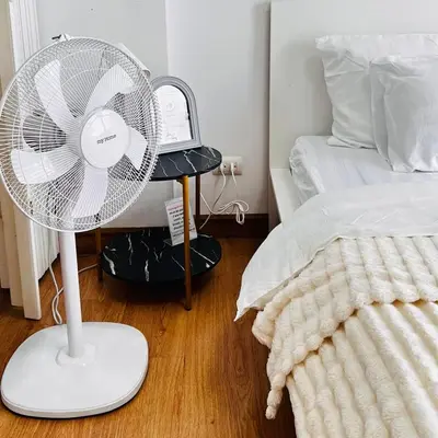 a white fan in a bedroom next to a bed at Vista Phuket Old Town Gym Pool Wifi Netflix Walk to All in Phuket Town