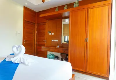 a bedroom with a white bed and a bathroom at Villa with Private Pool in Rawai in Rawai Beach