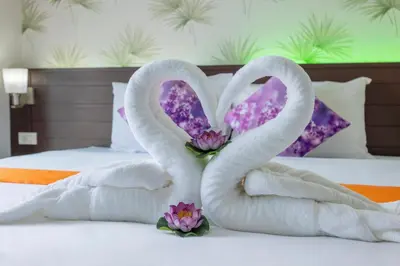 two swans made out of towels on a bed at The Chic Patong Hotel in Patong Beach