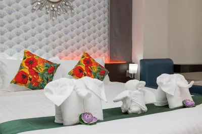 a hotel room with a bed with figurines of elephants at The Chic Patong Hotel in Patong Beach