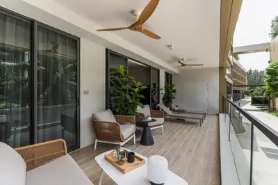 an open living room with a ceiling fan at NEW! Laguna Beachside Apt 100 m2 in Ban Thalat Choeng Thale