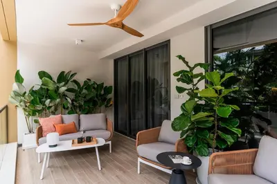a living room with two couches and a ceiling fan at NEW! Laguna Beachside Apt 100 m2 in Ban Thalat Choeng Thale