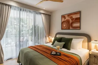 a bedroom with a bed and a large window at NEW! Laguna Beachside Apt 100 m2 in Ban Thalat Choeng Thale