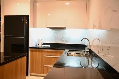 a kitchen with a black and white counter top at The Pelican Suite Residence Condo Klong Muang, Krabi in Klong Muang Beach