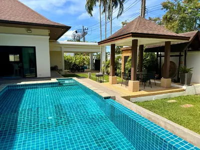 a swimming pool in front of a house at BlueElephant Villa NaiHarn in Rawai Beach