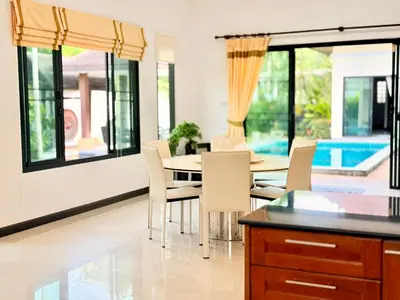 a dining room with a table and chairs at BlueElephant Villa NaiHarn in Rawai Beach